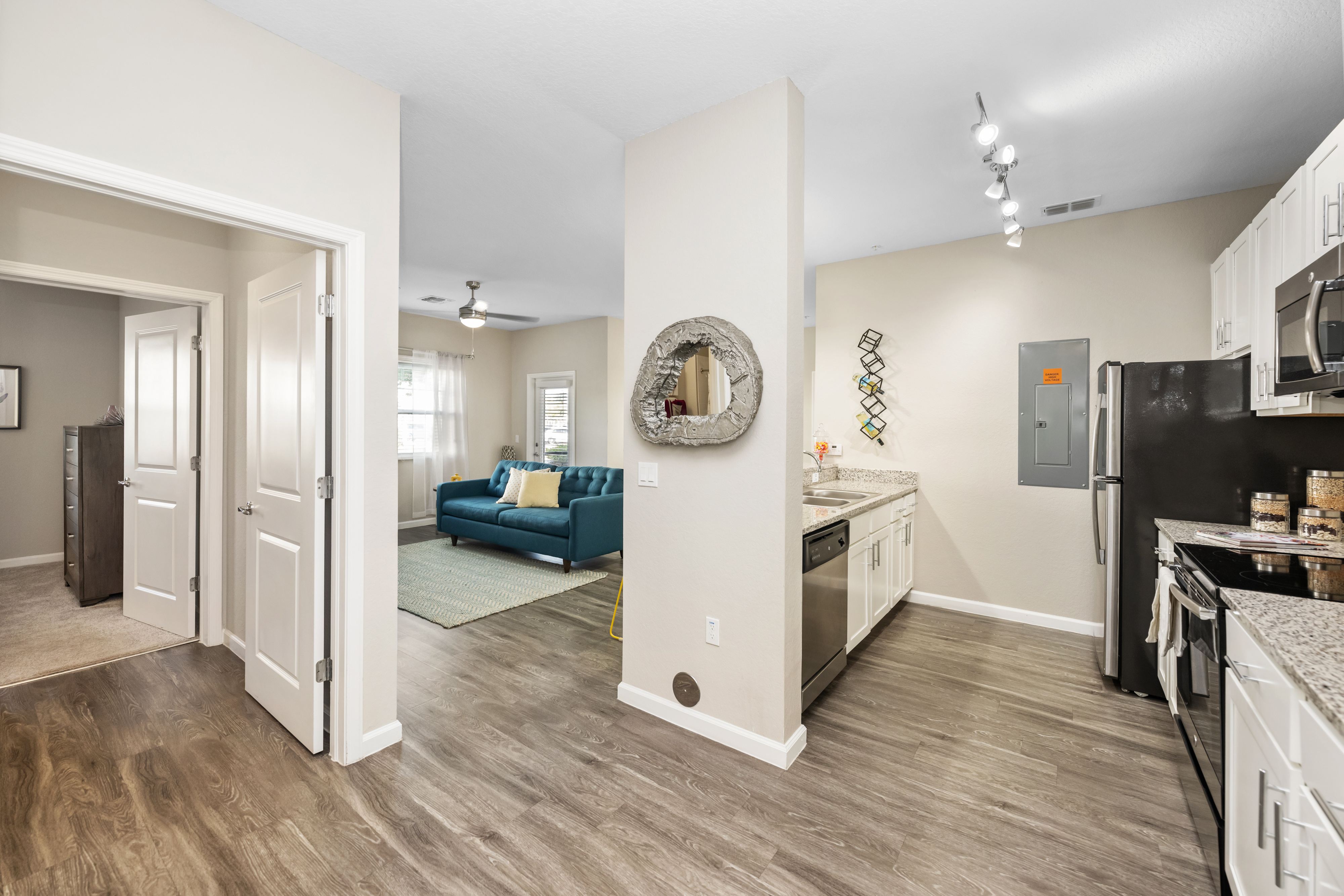 A kitchen with a refrigerator, oven, and microwave.